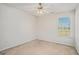 Bright bedroom featuring a ceiling fan and large window at 225 Chinns Way, Hampton, GA 30228
