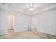Well-lit bedroom featuring an en-suite bathroom and multiple entry doors at 225 Chinns Way, Hampton, GA 30228
