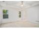 Bright bedroom featuring two windows for natural light, complemented by a ceiling fan at 225 Chinns Way, Hampton, GA 30228