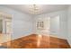 Bright dining room with wood floors, large windows, and classic lighting at 225 Chinns Way, Hampton, GA 30228