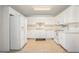 Well-lit kitchen featuring white cabinets and ample counter space at 225 Chinns Way, Hampton, GA 30228