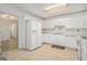 Well-lit kitchen featuring white cabinets and ample counter space at 225 Chinns Way, Hampton, GA 30228