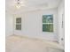 Neutral main bedroom with carpet, two windows, and ceiling fan at 225 Chinns Way, Hampton, GA 30228