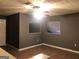 Living room with hardwood floors, neutral walls, and two square windows at 6434 Wellington Chase Ct, Lithonia, GA 30058