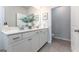 Bathroom with double sinks, a large decorative vase, framed art, and tile flooring at 10454 Trellis Lane (Lot 39), Hampton, GA 30228