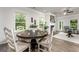 Inviting dining room featuring a stylish round table, natural lighting, and wood flooring at 10454 Trellis Lane (Lot 39), Hampton, GA 30228