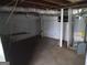 Unfinished basement showing exposed utilities, pipes, and a concrete floor at 106 Flippen Rd, Stockbridge, GA 30281