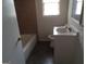 Bathroom with tiled floors, white vanity and a combined shower and tub at 106 Flippen Rd, Stockbridge, GA 30281