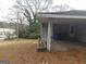 Carport, bins for trash and recycling and potential for planting in the front yard at 106 Flippen Rd, Stockbridge, GA 30281