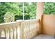 Balcony featuring a white painted balustrade with stucco walls overlooking a lush green landscape at 956 Shadowford Fls, Lithonia, GA 30058