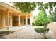 Rear exterior view of a home, showcasing a covered patio with columns, natural landscaping and pea gravel at 956 Shadowford Fls, Lithonia, GA 30058