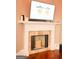 Beautiful fireplace and mantle with stone tile detail, plus a large screen TV at 956 Shadowford Fls, Lithonia, GA 30058