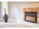 Inviting fireplace with tan tile surround next to large sunny windows at 956 Shadowford Fls, Lithonia, GA 30058