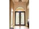 Elegant entryway featuring an ornate iron front door with arched detailing at 956 Shadowford Fls, Lithonia, GA 30058