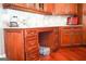 Custom kitchen with desk space and ample storage, featuring classic wood cabinets and granite countertops at 956 Shadowford Fls, Lithonia, GA 30058