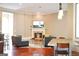 Open-concept living room with a fireplace, TV, and a grey seating arrangement with hardwood floors at 956 Shadowford Fls, Lithonia, GA 30058