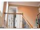 Interior view of a staircase with a wooden railing and decorative wrought iron, offering an elegant design at 956 Shadowford Fls, Lithonia, GA 30058