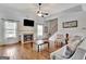 Bright living room with fireplace, hardwood floors, and comfortable seating, offering a view of the staircase at 755 Becky Ct, Fayetteville, GA 30214