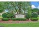 Whisper Creek community entrance sign surrounded by meticulously maintained landscaping and mature trees at 755 Becky Ct, Fayetteville, GA 30214