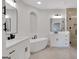 Spacious bathroom featuring dual vanities, soaking tub, glass shower, and modern fixtures at 118 Via Roma, Woodstock, GA 30188