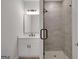 Sleek bathroom with glass shower, vanity, modern fixtures and bright lighting at 118 Via Roma, Woodstock, GA 30188