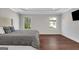 Primary bedroom featuring hardwood floors, neutral walls and two windows at 118 Via Roma, Woodstock, GA 30188