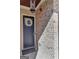 A beautiful black front door with glass, brick walls, a door mat and a white wreath at 118 Via Roma, Woodstock, GA 30188