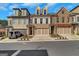Beautiful townhomes feature brick and stone accents, with a two car garage and manicured landscaping at 118 Via Roma, Woodstock, GA 30188