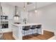 Bright kitchen featuring a large island with counter seating and stainless appliances at 118 Via Roma, Woodstock, GA 30188