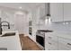 Modern kitchen with white cabinets, stainless steel appliances, and hardwood floors at 118 Via Roma, Woodstock, GA 30188