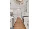 Modern white kitchen featuring stainless steel appliances, hardwood floors, and an open floor plan at 118 Via Roma, Woodstock, GA 30188