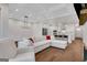 Spacious living room with modern light fixture and view into open kitchen at 118 Via Roma, Woodstock, GA 30188