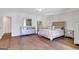 Bright bedroom with hardwood floors, mirrored dresser, and contemporary furniture at 118 Via Roma, Woodstock, GA 30188