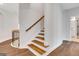 Elegant staircase with wood treads and railing, bright lighting, and modern design at 118 Via Roma, Woodstock, GA 30188