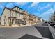 Street view of newly constructed townhomes with well-maintained landscaping and attached garages at 118 Via Roma, Woodstock, GA 30188