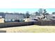 View of the backyard with fence, showing the neighboring homes at 611 Winners Cir, Locust Grove, GA 30248