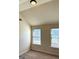 Neutral bedroom with two sunny windows and tan carpeted floors at 611 Winners Cir, Locust Grove, GA 30248