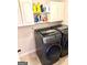 Laundry room features a modern washer and dryer with cabinets for storage at 611 Winners Cir, Locust Grove, GA 30248