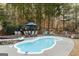 Outdoor pool area, complete with a hot tub, patio furniture and an umbrella at 104 Summer Chase, Carrollton, GA 30116