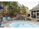 Private backyard retreat with a pool, mature trees, and plenty of seating at 104 Summer Chase, Carrollton, GA 30116