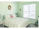 Bright bedroom with a large window, floral bedding, and carpet flooring at 104 Summer Chase, Carrollton, GA 30116