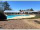 Community pool area featuring a large in-ground pool, pool house, and surrounding greenery at 104 Summer Chase, Carrollton, GA 30116