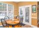 Sunlit kitchen nook with a table, chairs, and a view to the patio at 104 Summer Chase, Carrollton, GA 30116