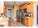 Kitchen with stainless steel appliances and granite counters; view to another room at 104 Summer Chase, Carrollton, GA 30116