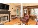 Inviting living room with a fireplace, hardwood floors, and a view into the dining area at 104 Summer Chase, Carrollton, GA 30116