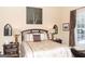 Tranquil main bedroom featuring lamps, a decorative headboard, and warm lighting at 104 Summer Chase, Carrollton, GA 30116