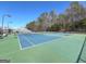 Community tennis courts featuring the green and blue painted surfaces and nets surrounded by bare trees at 104 Summer Chase, Carrollton, GA 30116