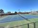 Community tennis court showing the green and blue painted surface and net from behind a chain link fence at 104 Summer Chase, Carrollton, GA 30116