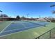 Community tennis court featuring the green and blue painted surfaces and nets surrounded by bare trees at 104 Summer Chase, Carrollton, GA 30116