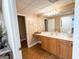 Bathroom vanity area with a large mirror and wooden drawers at 8179 Pineview Ct, Villa Rica, GA 30180